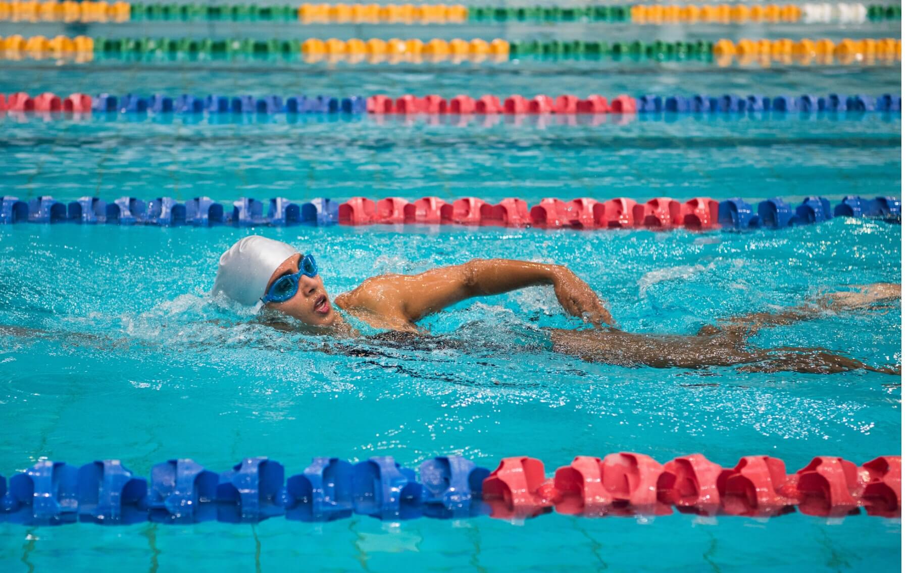 Person swimming in an Olympic pool